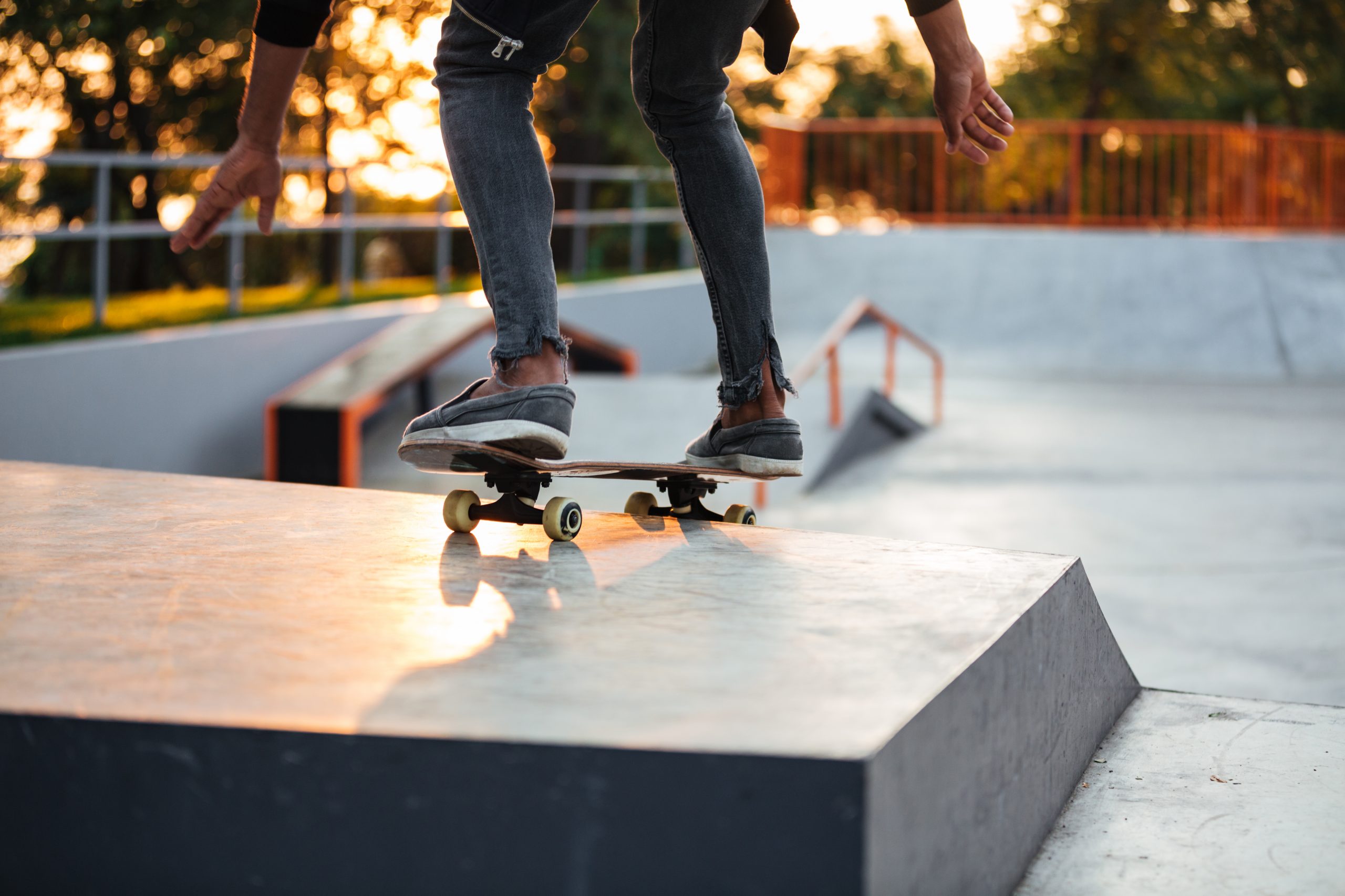 Cropped image of a skater boy practicing at the skate park